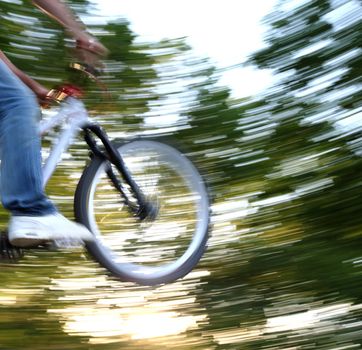 young airborne bmx biker (motion blur is used to convey movement)