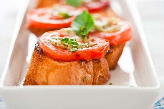 Bruschetta - gold baked baguette with tomato garlic and basil as appetizer