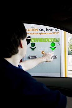 Man taking toll ticket from machine