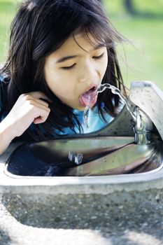 Girl drinking from water fountain