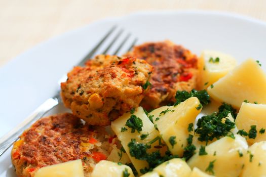 Meatballs with potatoes on a plate with a fork