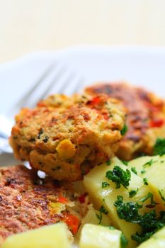 Meatballs with potatoes on a plate with a fork