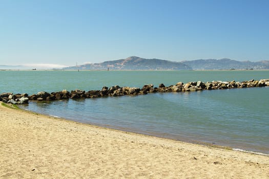 Beach with mountains on background on sunny day