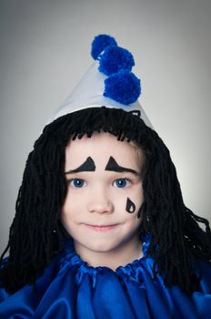 portrait child in costume Piero  on gray background