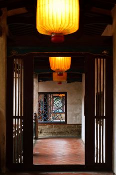 Chinese traditional hallway in wooden with yellow lantern.