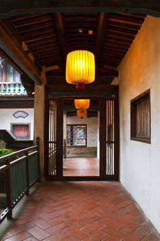 Chinese traditional corridor in wooden with yellow lantern.