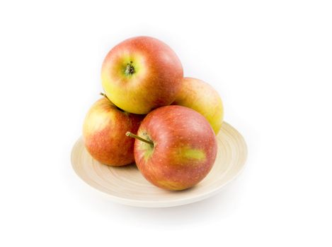Stripped apples on plate on white background