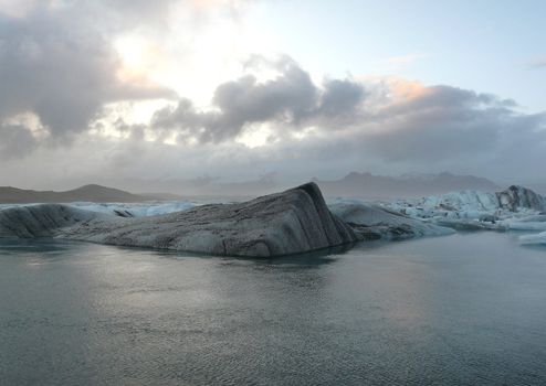 Clouds over the floating icebergs in Jokulsarlon glacier lake in Iceland.