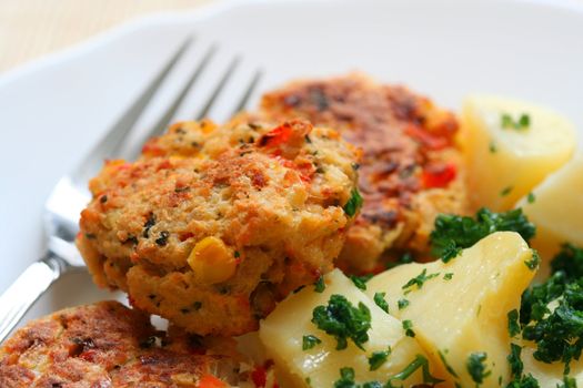 Meatballs with potatoes on a plate with a fork