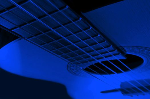 Acoustic guitar with extreme blue light effect.