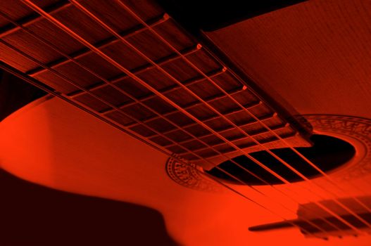 Acoustic guitar with extreme red light effect.