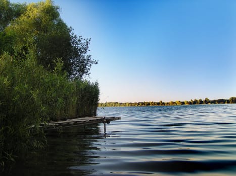 Pier in the lake with small waves