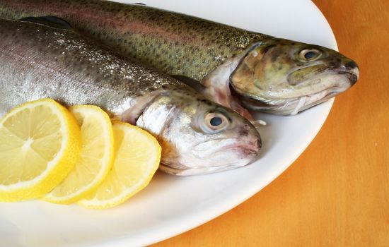 Fish with lemon on the plate