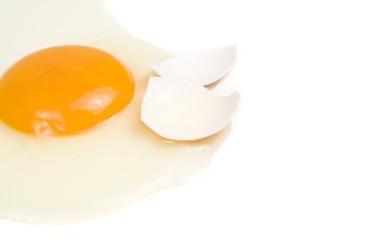 Broken egg with yolk on white background