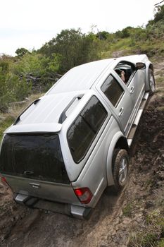 An offroad 4x4 vehicle negotiang a steep climb