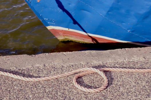 rope in the sea wharf and blue ship fragment