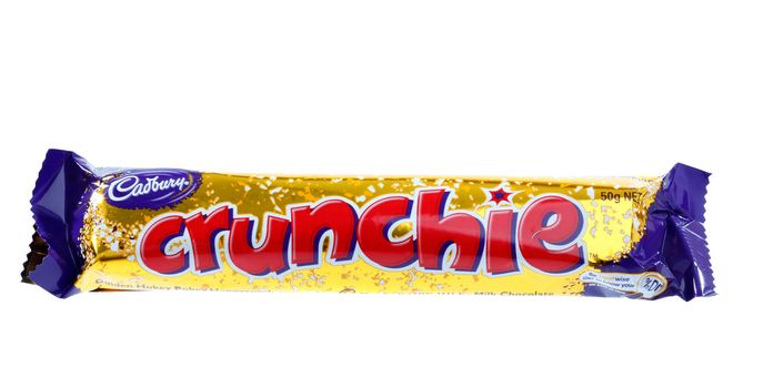 Cadbury Crunchie chocolate and golden hokey pokey honeycomb bar.  Shown 50g (995kj)  
Crunchie bar is available in 50g, 80g, 216g Share Packs and 18g Special Treats pieces.  White background.  Editorial Use Only.