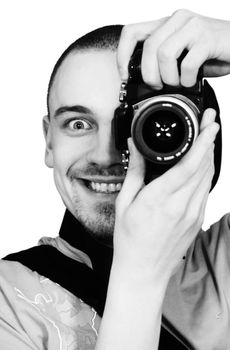 young man with a photographic camera staring from behind the camera
