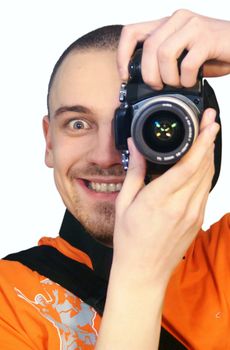 young man with a photographic camera staring from behind the camera
