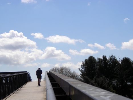 An old age runner, climbing upwards a ramp.