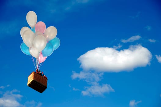 Helium balloons is lifting basket with people.