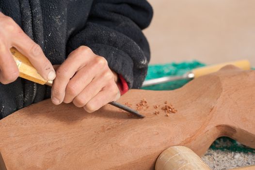 Sculptor working on his art at his workshop