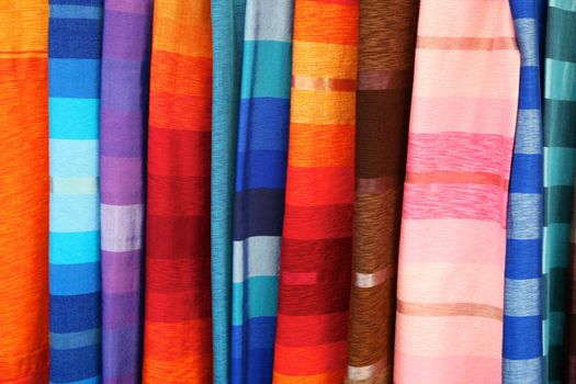 Selection of wonderfully bright colourful cloth at a market stall in Fez, Morocco
