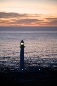 Lighthouse in the sea at simons town during a beautiful sunset