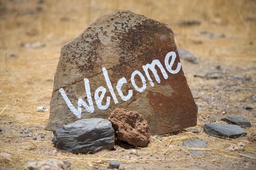Welcome message written on a rock at the entrance of a national park in Namibia