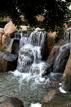 Waterfall feature with cascading water and rocks