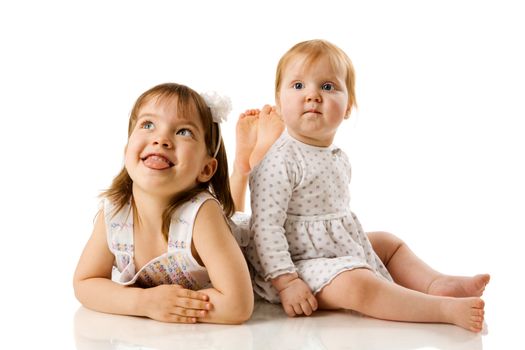 Two little Sisters playing together isolated on white