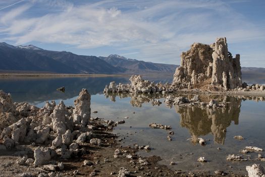 Tufa towers of mineral deposits appear to rise from the waters of Mono Lake.  Mono County, California, USA, near the town of Lee Vining.  On the eastern slope of the Sierra Nevada mountain range.