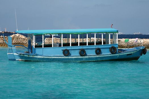 Ship in the Maldives cruising between the reef