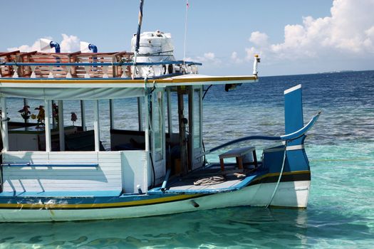 Ship in the Maldives cruising between the reef