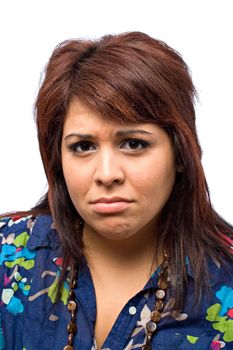 A pretty young hispanic woman isolated over a white background with a scowling frown on her face.