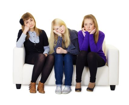 Three bored friends sitting on the couch. White isolated background