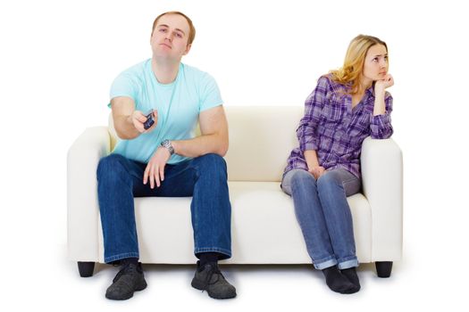 A husband and wife in a quarrel sit on the couch watching TV isolated on white background