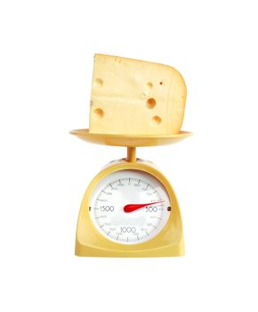 Piece of cheese lying on nice yellow kitchen scale. Isolated on white with clipping path