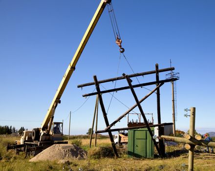 Replacing old power line supports using the crane