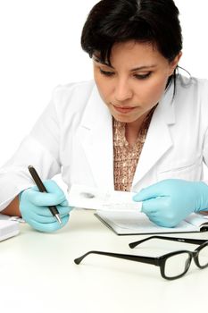 A female forensic scientist holds a fingerprint sample ready for further analysis.