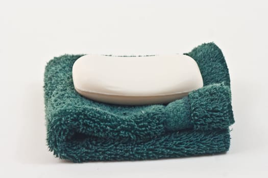 Bar of SoapBar of soap on a wash cloth, white background