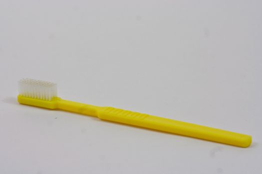 Plain yellow Truthbrush on a white background.