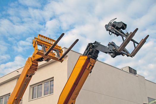 Lift trucks, fenwicks, on blue sky, waiting to be used