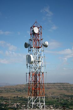 A telecommunication tower setup on a hilltop in rural India.
