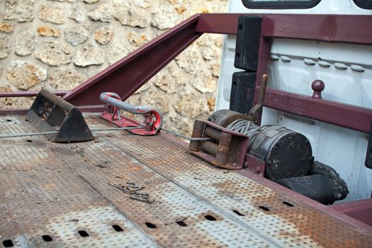 Close-up on the winch of an automobile tow truck