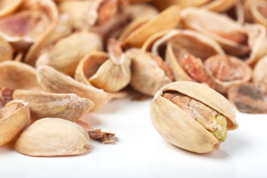 Macro view of last pistachio in the heap of nutshells