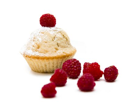 Muffins with raspberries isolated over a white background