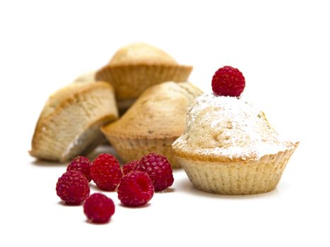 Muffins with raspberries isolated over a white background