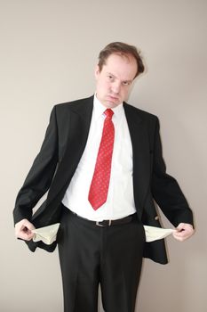 businessman with empty pockets denoting financial loss and frusration