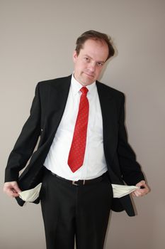 businessman with empty pockets denoting financial loss and frustration